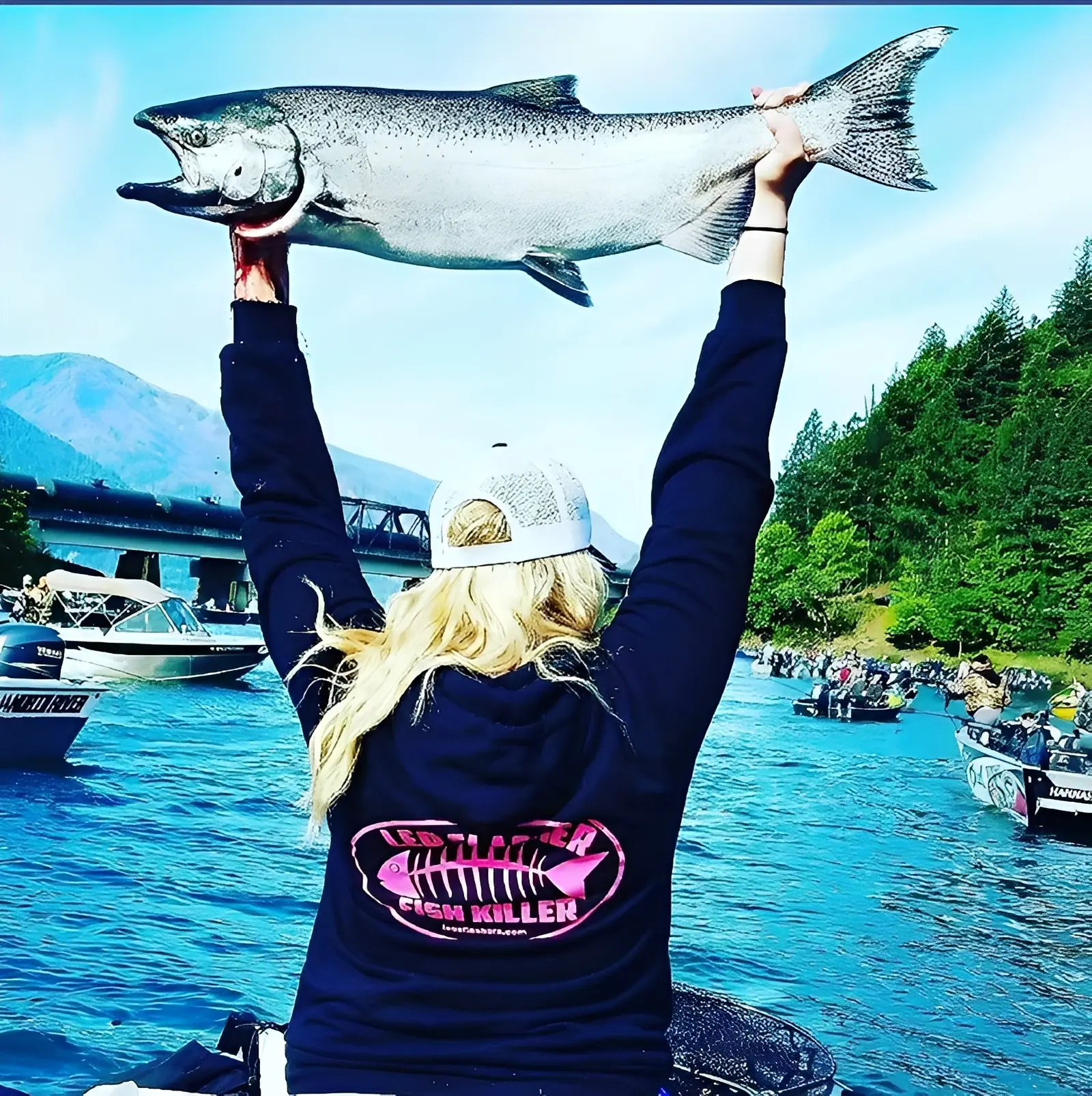 Person holding a large fish on boat.