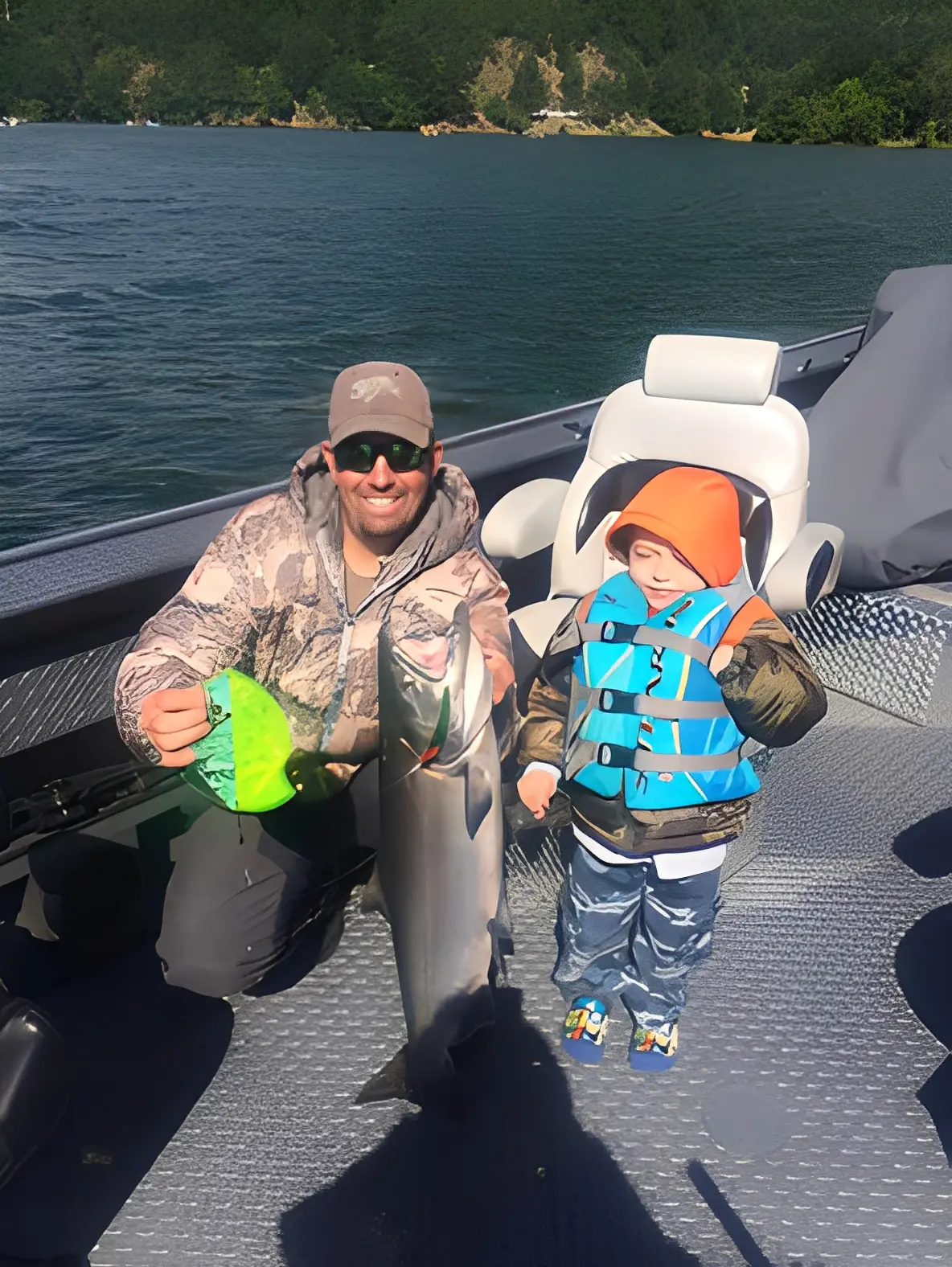 Man and child with fish on boat.