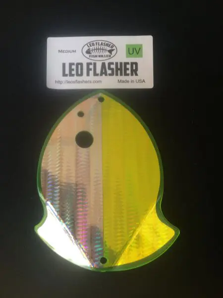 A yellow and reflective fishing lure shaped like a fish.