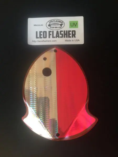 A small fish-shaped LED flasher with a red and metallic body.