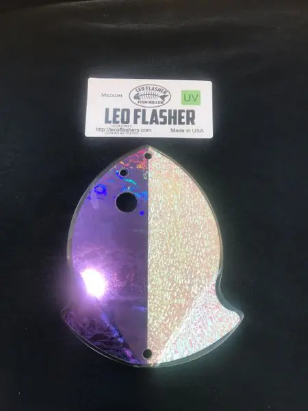 LED flasher light emitting purple glow on a dark surface.