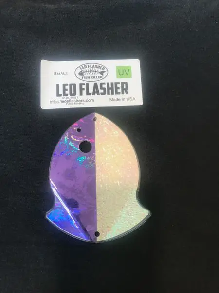 A colorful, iridescent Leo Flasher fishing lure with a curved shape.