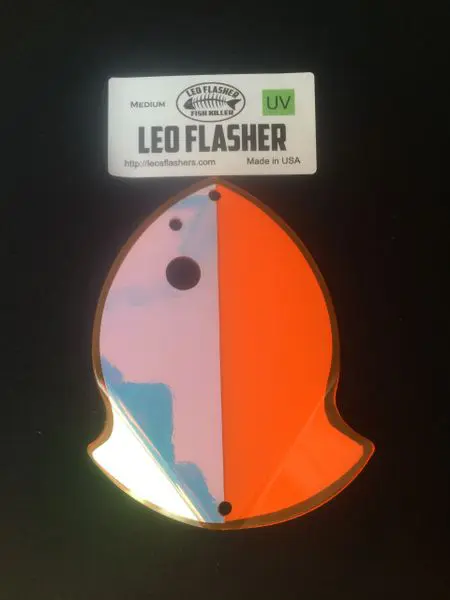 A colorful LED flasher shaped like a fish with bright orange and blue sections.