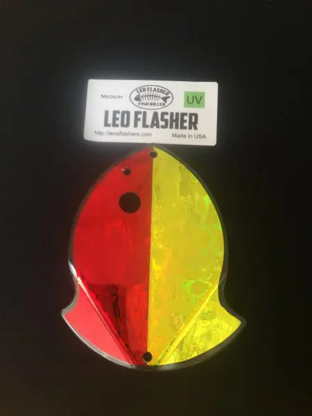 Red and yellow LED flasher shaped like a fish, packaged.