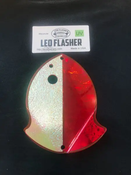 A red and white fish-shaped LED flasher light.