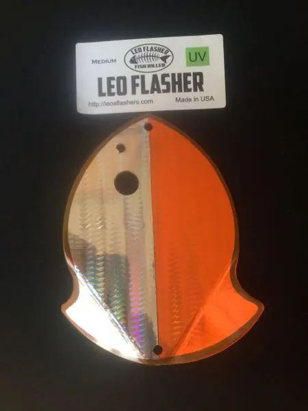 A reflective orange and silver LED flasher shaped like a fish.