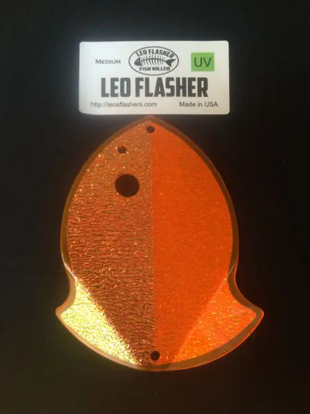 Orange LED flasher shaped like a fish with a black dot eye.