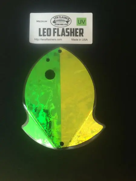Reflective LED flasher shaped like a fish in green and yellow.