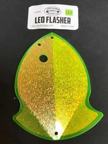 Glittery green and yellow fish-shaped sticker with a black eye.