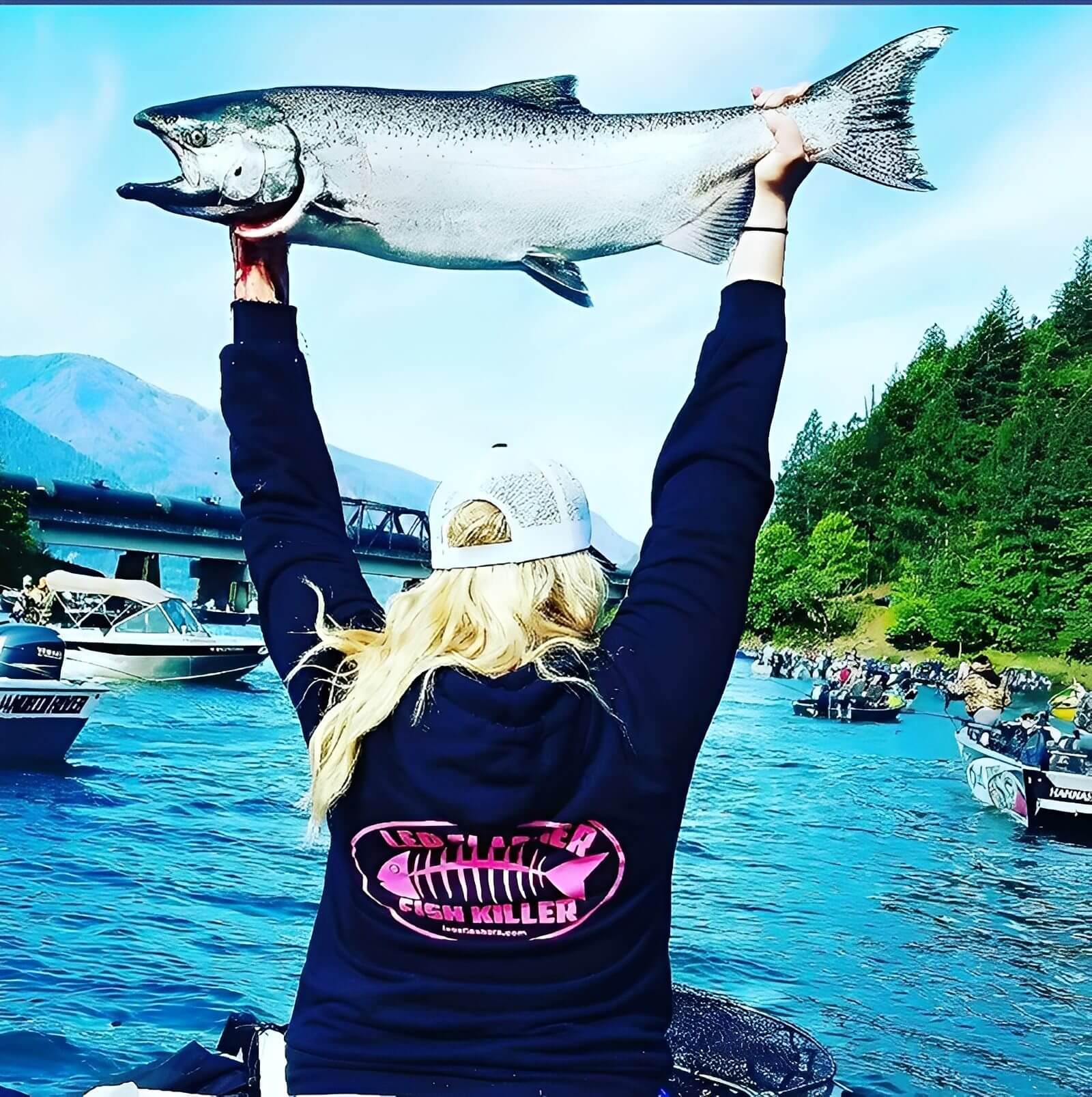 Person holding a large fish on boat.
