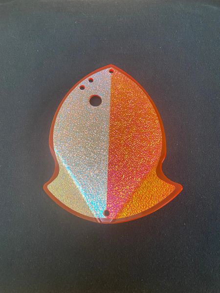 Colorful fish-shaped keychain with glitter and holes on top.
